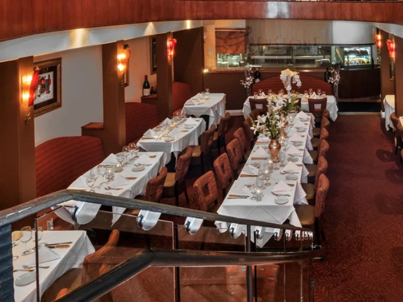 The Roxy semi-private lower dining room set for a group holi The Roxy semi-private lower dining room set for a group holiday dinner